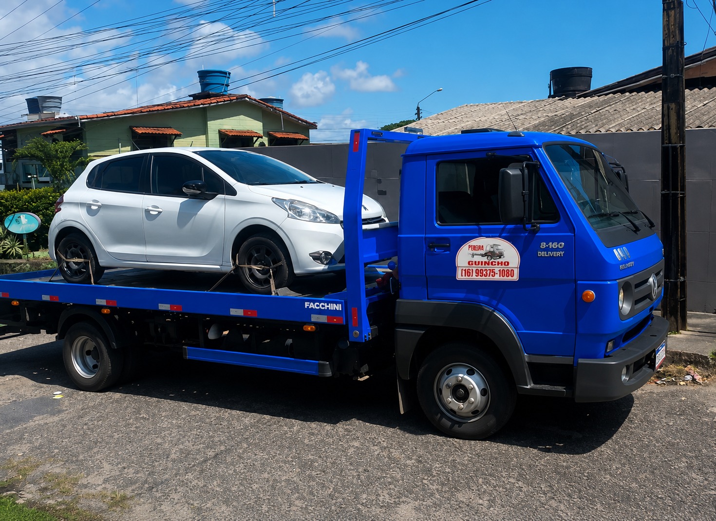 Guincho plataforma azul Pereira transportando hatch branco em Ribeirão Preto